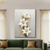 Textured white lily flower canvas wall art with golden accents and green leaves on beige neutral background for elegant home decor.