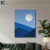 Minimalist Blue Wall Art featuring a large grey moon rising above layered geometric mountains in shades of navy and sky blue.