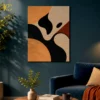 Abstract wall art with irregular dark curvy shapes in black, brown, and beige on a textured canvas.